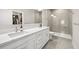 Modern bathroom with double sinks, white cabinets, stone countertops and walk-in shower at 2570 12Th N Pl, St Petersburg, FL 33713