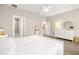 Bedroom with white walls and floors, featuring a view into the ensuite bathroom and closet at 2570 12Th N Pl, St Petersburg, FL 33713