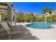 Inviting community pool area with lounge chairs and palm trees, perfect for relaxation and recreation at 2570 12Th N Pl, St Petersburg, FL 33713