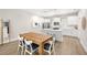 Bright dining area with a wooden table, white chairs, and a view into the modern kitchen at 2570 12Th N Pl, St Petersburg, FL 33713