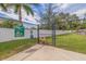 Community dog park with secure fencing, green grass, and pet waste station for residents at 2570 12Th N Pl, St Petersburg, FL 33713
