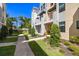 Well-manicured landscaping leads to the townhome entrance with a charming bench and covered entryway at 2570 12Th N Pl, St Petersburg, FL 33713