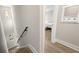 Hallway stairs lead to bedroom with wood floors, white trim, and modern design elements at 2570 12Th N Pl, St Petersburg, FL 33713