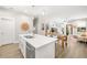 Open concept kitchen with white cabinets, marble countertops, and an island with sink and bar seating at 2570 12Th N Pl, St Petersburg, FL 33713