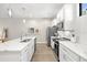 Clean, well-lit kitchen with white cabinets, stainless steel appliances, and marble countertops at 2570 12Th N Pl, St Petersburg, FL 33713