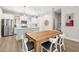 Modern eat-in kitchen with stainless steel appliances, white subway tile backsplash, and a wooden dining table at 2570 12Th N Pl, St Petersburg, FL 33713