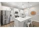 Bright kitchen featuring white cabinets, stainless steel appliances, and a large center island with seating at 2570 12Th N Pl, St Petersburg, FL 33713