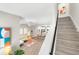 Open concept living area with stairs, modern furnishings, and light wood floors at 2570 12Th N Pl, St Petersburg, FL 33713