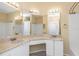 Bright bathroom with double sink vanity, granite countertop, and tile floors at 2730 Via Tivoli # 321B, Clearwater, FL 33764