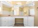 Bathroom with double sink vanity, granite countertop, tile floor, and a mirror at 2730 Via Tivoli # 321B, Clearwater, FL 33764