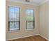 Bright bedroom with two windows, wood floor, and neutral colored walls at 2730 Via Tivoli # 321B, Clearwater, FL 33764
