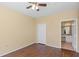 Bedroom with a ceiling fan, wood floors, closet, and an ensuite bathroom at 2730 Via Tivoli # 321B, Clearwater, FL 33764