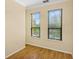 Bright bedroom with two windows, wood floor, and neutral colored walls at 2730 Via Tivoli # 321B, Clearwater, FL 33764