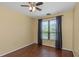 Bedroom features a ceiling fan, wood floors, and window with natural light at 2730 Via Tivoli # 321B, Clearwater, FL 33764