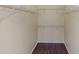 Walk-in closet with white wire shelving and wood floors at 2730 Via Tivoli # 321B, Clearwater, FL 33764