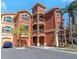 Stunning exterior view of a three-story condominium building with private balconies and lush landscaping at 2730 Via Tivoli # 321B, Clearwater, FL 33764