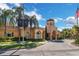 Grand Bellagio clubhouse entrance, featuring lush landscaping, palm trees, and architecture at 2730 Via Tivoli # 321B, Clearwater, FL 33764