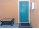 Apartment entrance with bench and colorful door at 2730 Via Tivoli # 321B, Clearwater, FL 33764