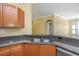 Kitchen boasting granite countertops, stainless steel appliances, and a dual basin sink with views to the living room at 2730 Via Tivoli # 321B, Clearwater, FL 33764