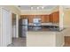 Well-equipped kitchen featuring stainless steel appliances, granite countertops, and a view of the laundry at 2730 Via Tivoli # 321B, Clearwater, FL 33764