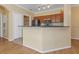 Well-lit kitchen with stainless steel appliances, granite countertops, and convenient breakfast bar overlooking the living space at 2730 Via Tivoli # 321B, Clearwater, FL 33764