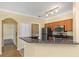 Open kitchen with stainless steel appliances, granite countertops, and a convenient view to the laundry room at 2730 Via Tivoli # 321B, Clearwater, FL 33764