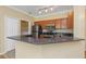 Open kitchen featuring stainless steel appliances, granite countertops, and a breakfast bar, perfect for casual dining at 2730 Via Tivoli # 321B, Clearwater, FL 33764