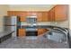 Cozy kitchen with stainless steel appliances, granite countertops, and ample cabinet space for storage at 2730 Via Tivoli # 321B, Clearwater, FL 33764