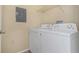 Laundry room featuring a washer and dryer, wire shelving, and clean interiors at 2730 Via Tivoli # 321B, Clearwater, FL 33764