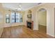 Bright living room featuring a fireplace, large windows with natural light, and hardwood flooring at 2730 Via Tivoli # 321B, Clearwater, FL 33764