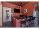 Outdoor bar area with granite countertop, television, seating, and outdoor access at 2730 Via Tivoli # 321B, Clearwater, FL 33764