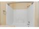 Bright, all-white tile shower with a shower head and grab bar at 2730 Via Tivoli # 321B, Clearwater, FL 33764