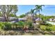 Back of the home featuring a screened-in pool and lush tropical landscaping for privacy at 2905 Hillside Ramble Dr, Brandon, FL 33511