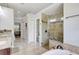 Bathroom featuring tile floors, granite countertops, a large soaking tub, and walk-in glass shower at 2905 Hillside Ramble Dr, Brandon, FL 33511