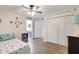 Bright bedroom with wood floors, nautical decor, and an en suite bathroom at 2905 Hillside Ramble Dr, Brandon, FL 33511