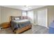 Spacious bedroom with wood-look floors, a ceiling fan, and natural light offers relaxation and style at 2905 Hillside Ramble Dr, Brandon, FL 33511
