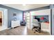 Well-lit bedroom features a unique loft bed with a built-in desk, wood-look floors, and cheerful decor at 2905 Hillside Ramble Dr, Brandon, FL 33511