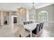 Elegant dining area featuring stylish light fixtures, plenty of sunshine, and an open transition to the foyer at 2905 Hillside Ramble Dr, Brandon, FL 33511