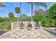 An outdoor fire pit with stone surround and chair seating provides an excellent relaxation space with views of nature at 2905 Hillside Ramble Dr, Brandon, FL 33511