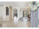 Bright and airy foyer with tile flooring, an open floor plan, and a glimpse of the living space at 2905 Hillside Ramble Dr, Brandon, FL 33511