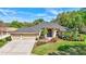 Charming home with a three-car garage, well-manicured lawn, and a lovely, arched entry at 2905 Hillside Ramble Dr, Brandon, FL 33511