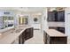 Stylish kitchen featuring granite countertops, dark wood cabinets, and an island at 2905 Hillside Ramble Dr, Brandon, FL 33511