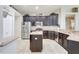Modern kitchen with stainless steel appliances, dark wood cabinetry, and tiled floors at 2905 Hillside Ramble Dr, Brandon, FL 33511