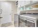 Well-lit laundry room with modern appliances and plenty of storage space at 2905 Hillside Ramble Dr, Brandon, FL 33511