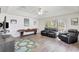 Bright living room features recessed lighting, wood-look floors, and a comfortable leather seating arrangement at 2905 Hillside Ramble Dr, Brandon, FL 33511