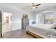 Comfortable main bedroom features hardwood floors, a ceiling fan, and soothing light blue walls at 2905 Hillside Ramble Dr, Brandon, FL 33511