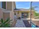 Brick-paved patio leads to a rear entry door with a clear view of playhouse and pool, enhancing backyard enjoyment at 2905 Hillside Ramble Dr, Brandon, FL 33511