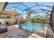 Enclosed pool with safety fence, comfortable seating, and scenic views provides a safe and relaxing environment at 2905 Hillside Ramble Dr, Brandon, FL 33511