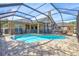 Backyard pool with screen enclosure, brick pavers, and safety fence at 2905 Hillside Ramble Dr, Brandon, FL 33511