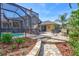 Screen-enclosed pool area with adjacent patio, playhouse, and a nearby fire pit provides relaxation and recreation at 2905 Hillside Ramble Dr, Brandon, FL 33511